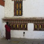 A Buddhist monk spinning prayer wheels in Bhutan