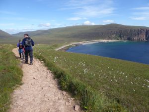 Hiking on coastal trail in Scotland