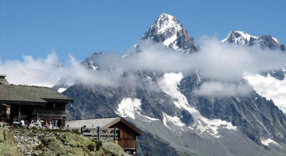 Mont Blanc massif in background, with wooden cabin in midground