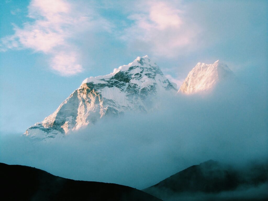 Clouds drift in front of the peak of Ama Dablam