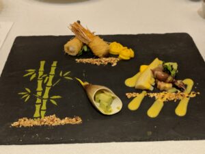 Japanese appetizers on a black plate 