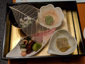 Japanese food: small bowls with leaf overlay photo. Deciding what to eat in Japan may be one of the challenges with so many amazing options!