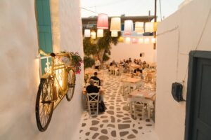 Slow travel in Naxos, Greece: people enjoying food and coffee